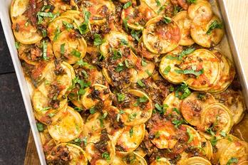 A pan of Recipes of Inspiration on top of a cutting board